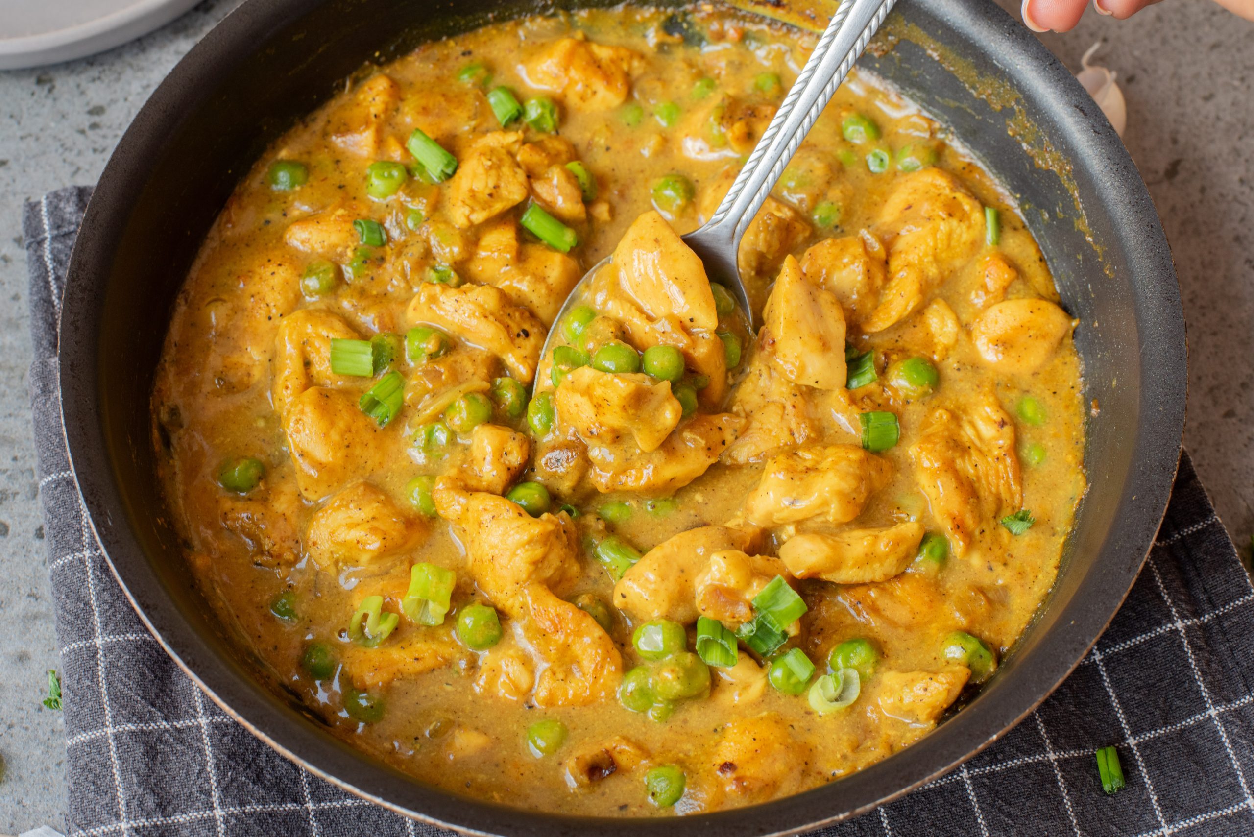 A bowl of food with a spoon.
