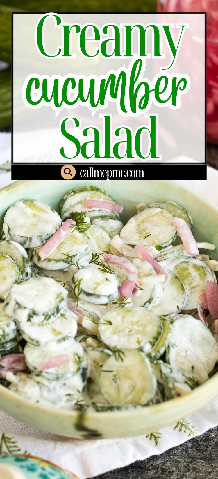 A bowl of creamy cucumber salad with sliced cucumbers, red onions, and fresh dill in a light dressing, served on a table.