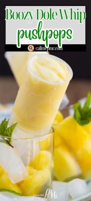 Close-up of a yellow frozen pushpop in a glass, surrounded by pineapple chunks, mint leaves, and ice. Text reads "Boozy Dole Whip pushpops callmepmc.com.