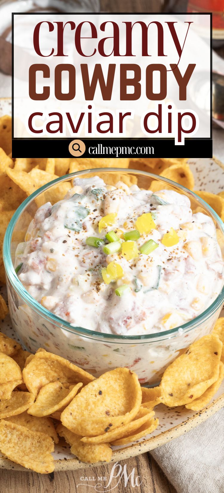A glass bowl of Creamy Cowboy Caviar Dip garnished with chopped peppers, surrounded by crisp corn chips.