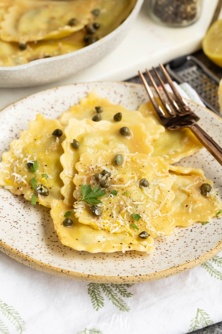 A plate of ravioli topped with grated cheese, capers, herbs, and a fork on the side.