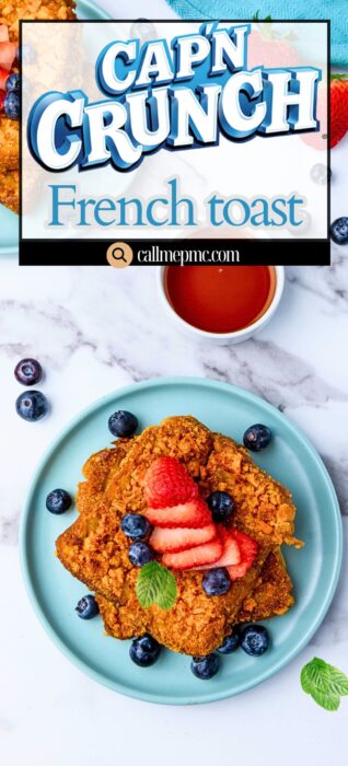 A plate with two slices of Cap’n Crunch French toast topped with sliced strawberries, blueberries, and a mint leaf sits on a marble surface with a bowl of syrup nearby; the recipe title is displayed above.