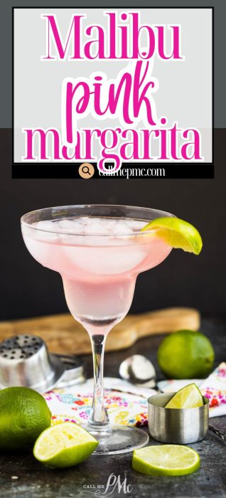 A pink margarita in a stemmed glass garnished with a lime wedge, surrounded by fresh lime pieces and a cocktail shaker on a colorful napkin.