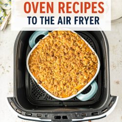 A casserole dish with a crumble topping sits inside an air fryer basket. Text above reads: “How to convert oven recipes to air fryer for easy and delicious meals.”.