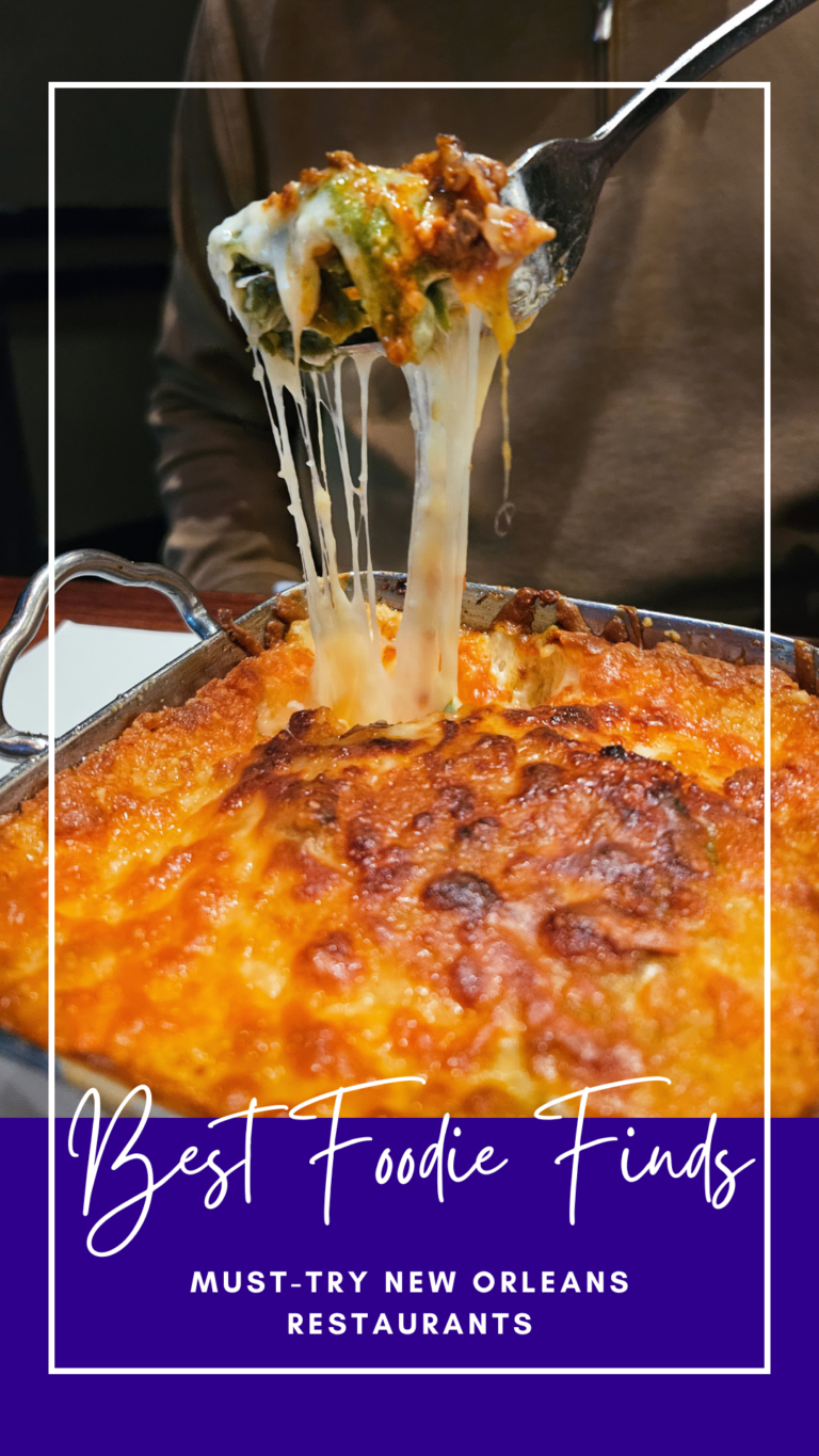 A close-up of a cheesy, baked pasta dish being served, with melted cheese stretching from the pan and the text "Best Foodie Finds: Must-Try New Orleans Restaurants" over a purple banner at the bottom.