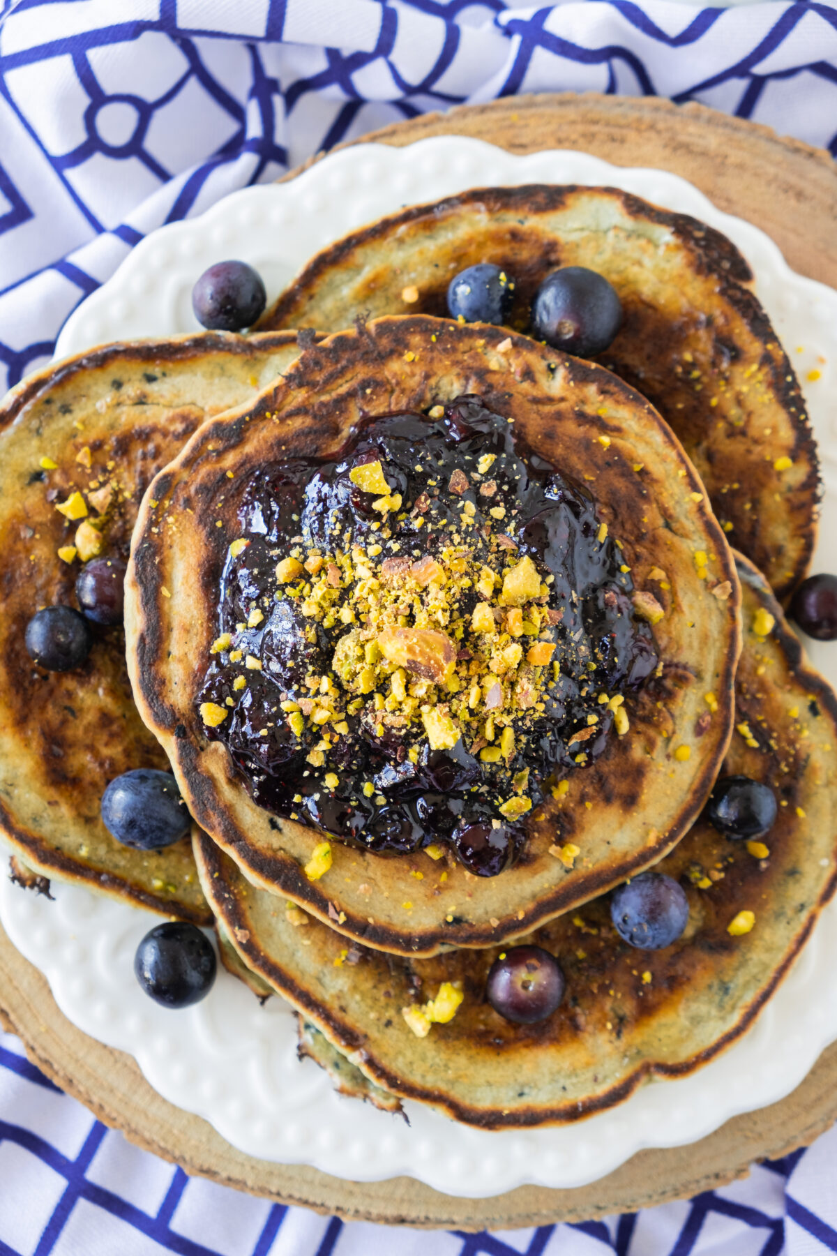A Gluten-free brunch recipe, sits on a white plate, placed on a blue and white patterned cloth.